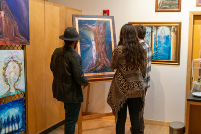 People looking at sacred art in the cosmo art gallery